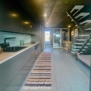 a kitchen with a sink and a counter with a rug at Seaside Boathouse In Veiholmen in Smøla