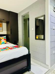 a bedroom with a bed and a tv on a wall at Welcome to Shangri-La in Kigali