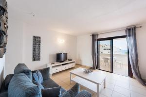 a living room with a couch and a table at Paloma Beach Apartments in Los Cristianos