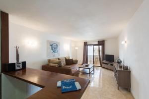 a living room with a couch and a table at Paloma Beach Apartments in Los Cristianos