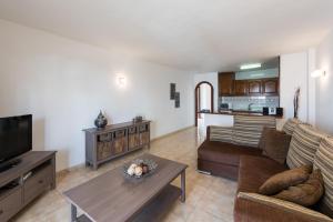 a living room with a couch and a table at Paloma Beach Apartments in Los Cristianos