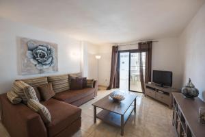 a living room with a couch and a coffee table at Paloma Beach Apartments in Los Cristianos