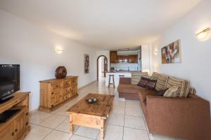 a living room with a couch and a table at Paloma Beach Apartments in Los Cristianos