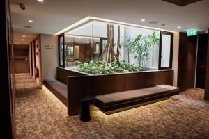 a lobby with a large aquarium in a building at Manon Boutique Hotel Kota Lama Semarang in Semarang