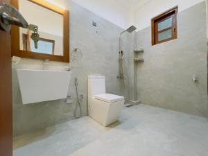 a bathroom with a shower and a toilet in it at Isuru villa in Matara +11 photos