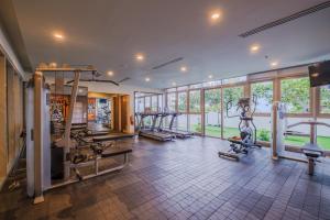 a gym with several treadmills and machines in a room at Luxury Corner Suite 1 Bedroom plus Den Top Floor Birds Eye View Spacious 668 square Feet in Iloilo City