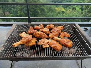 a bunch of food cooking on a grill at Stag Mountain Resort in Ettampitiya