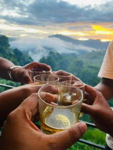 a group of people holding up glasses of wine at Stag Mountain Resort in Ettampitiya