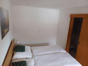 a small bedroom with two beds in a room at Mühlreithof in Kirchdorf in Tirol