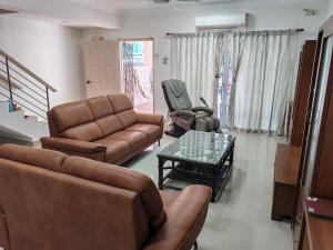 a living room with a couch and chairs and a table at 4 Bedrooms 4 Bathrooms 10Pax Comfy Sleeps Landed Spacious House in Seri Kembangan +10 photos