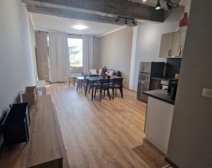 a kitchen and living room with a table and chairs at Concrete comfort in Samokov