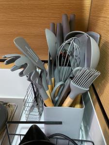 a white container filled with utensils on a counter at Makati Ayala luxury Stylish Uncle Sam condo Gym Swim Park 300 Mb 2641 in Manila +40 photos