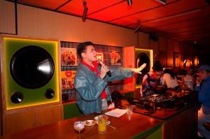 a man standing at a bar eating food at CLASSYC Hotel in Hanoi