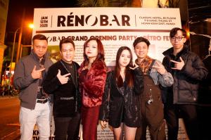 a group of people standing in front of a sign at CLASSYC Hotel in Hanoi