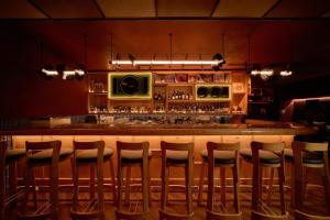 a bar with a row of stools in a restaurant at CLASSYC Hotel in Hanoi