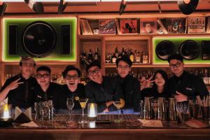a group of people sitting at a bar at CLASSYC Hotel in Hanoi