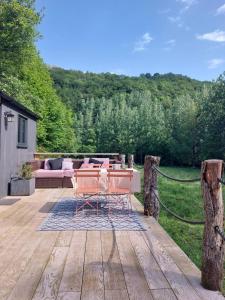 a patio with a table and chairs on a wooden deck at Roulotte in Cassagnes-Bégonhès +4 photos