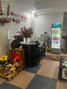 a kitchen with a counter in a store with flowers at Hồng Phát 68 Hotel in Ho Chi Minh City