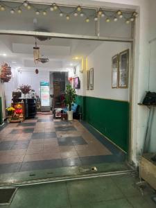 an empty room with a green wall and a hallway at Hồng Phát 68 Hotel in Ho Chi Minh City