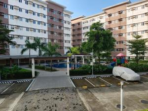 an empty parking lot in front of a building at Happy Stays D - 300mbps - 65"TV NetFlix, Disney - Washer in Trece Martires