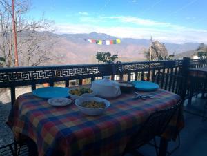 a table with bowls of food on top at Himalayan view stay - Pahado wala ghar in Mussoorie