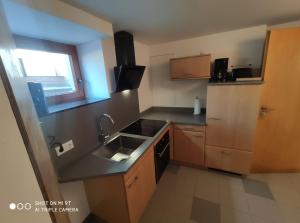 a small kitchen with a sink and a stove at Garda in Liebenburg