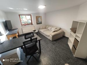 a living room with a couch and a table at Garda in Liebenburg