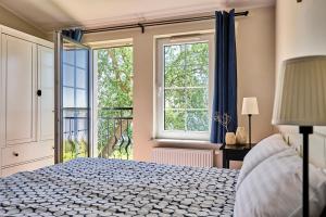 a bedroom with a bed and a large window at Kurort Stara Wędzarnia in Gdańsk