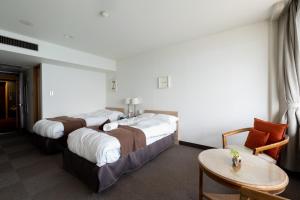 Postel nebo postele na pokoji v ubytování Isohara Seaside Hotel
