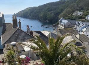 a view of a town with a river and houses at Cosy Beach Cottage - Cawsand in Cawsand