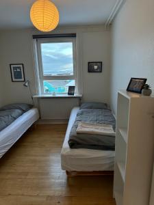 Postel nebo postele na pokoji v ubytování Illu Rental - Sea & City view Guesthouse