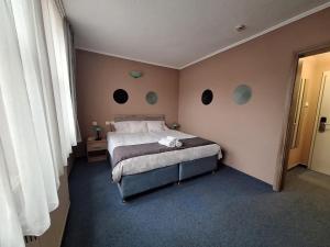 Postel nebo postele na pokoji v ubytování Hotel Unicornis