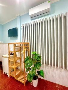 a room with a radiator and a curtain with plants at 31B Hotel - Near Ninh Kieu Wharf in Can Tho
