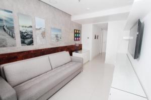 a living room with a couch and a television at Apartment Ocean View in Rio de Janeiro