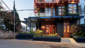 a building with a sign that reads the bike boutique at The Pink Boutique Hotel in Da Lat