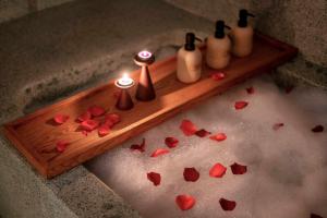 a wooden tray with candles and hearts on the floor at The Pink Boutique Hotel in Da Lat