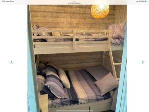 a bunk room with two bunk beds in it at Holiday Cabin Sleeps 5 Glan Gwna Holiday Park in Caernarfon +24 photos