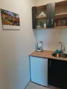 a kitchen with a sink and a counter top at Pension Volgenandt in Breitenbach