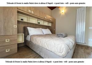 a bedroom with a large bed with a wooden headboard at CASTEL DI SANGRO - casa vacanza con wifi e posto auto vicino lo stadio in Castel di Sangro