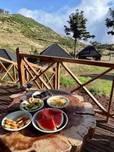 a table with plates of food on a wooden table at Mountain Eco Shelter 1 in Funchal +10 photos