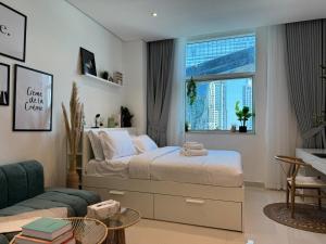 a bedroom with a bed and a large window at ASHRI HH, Bohemian Style Condo in Downtown in Dubai