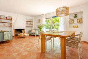 a dining room with a table and a living room at MASIA CENTENARIA EN SITGES in Sitges +46 photos