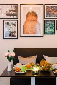 a table with food on it with pictures on the wall at Hotel Villa Solln - free parking in Munich