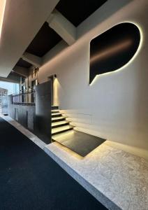 a staircase in a building with lights on the wall at Piranesi 246 in Milan
