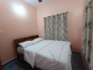Ένα ή περισσότερα κρεβάτια σε δωμάτιο στο Amruth Homestay Honavar Entire House +3 φωτογραφίες