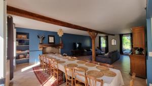 a large dining room with a long table and chairs at Le Moulin de mon Père, 20 pers, Piscine, campagne. in Dompierre-sur-Nièvre