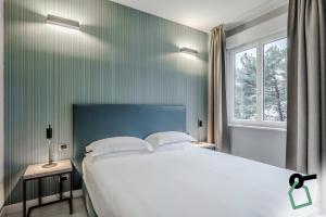 Postel nebo postele na pokoji v ubytování HOTIDAY Apartment Collection - La Spezia