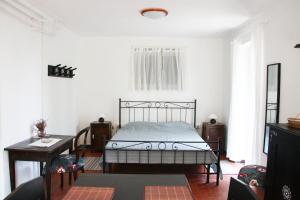 a bedroom with a bed and a table in it at Casa Luigia hillside getaway in Bracco