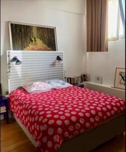 a bedroom with a bed with a red blanket at Superbe loft avec terrasse et jacuzzi aux Lilas près de Paris in Les Lilas