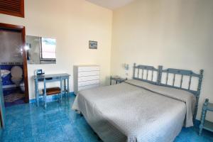 a bedroom with a bed and a sink and a desk at Hotel La Certosa in Massa Lubrense